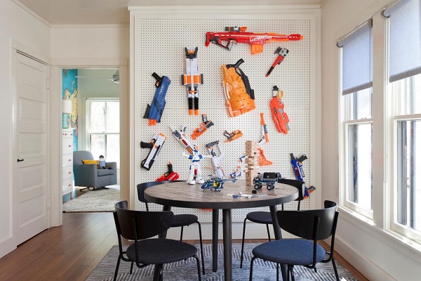 Toy nerf guns on a pegboard