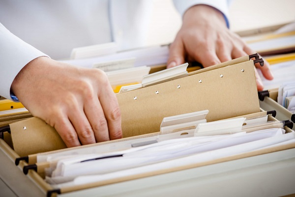 A businessman sorting through files